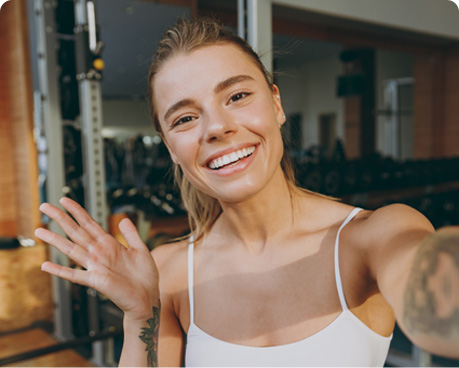 Reviewer smiling in a pilates class.